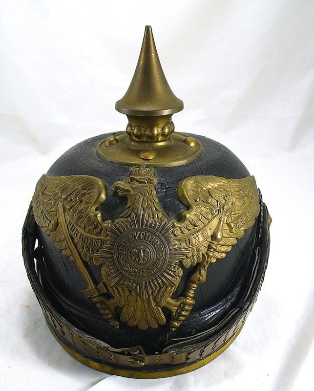 Black-and-gold ceremonial orb with eagle crest and pointed finial