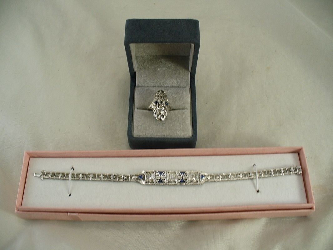 Bracelet and ring displayed in open black and pink jewelry boxes on a light surface