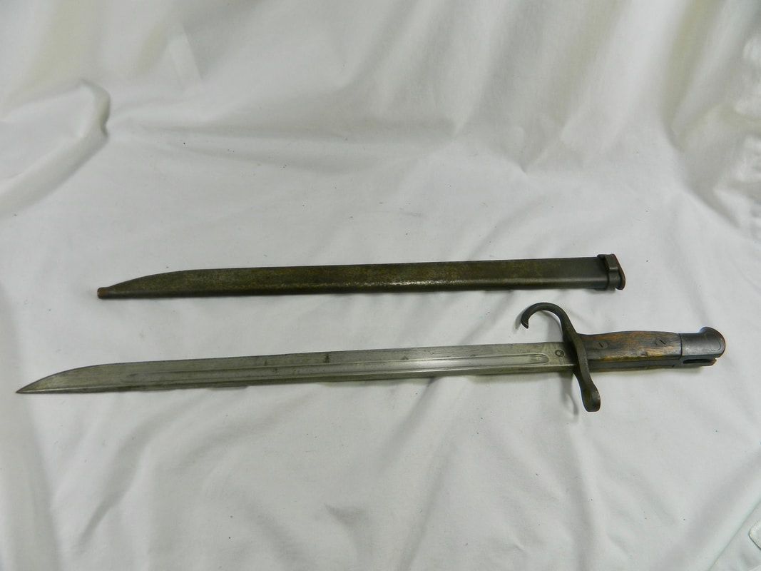 Two old swords with scabbards lying parallel on a white cloth background