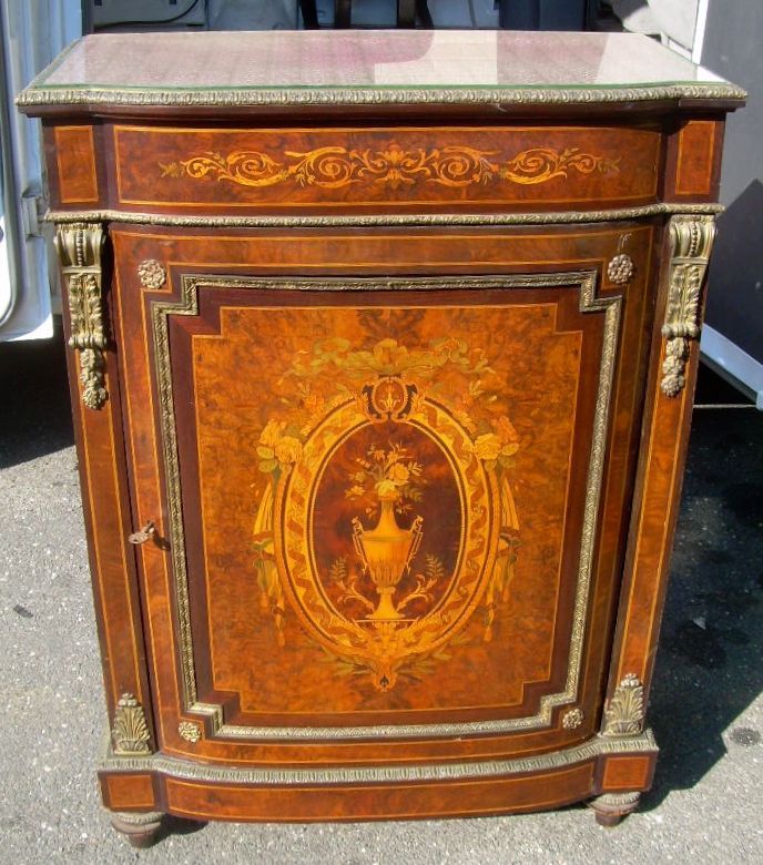 Ornate antique wooden cabinet with marquetry and a marble top