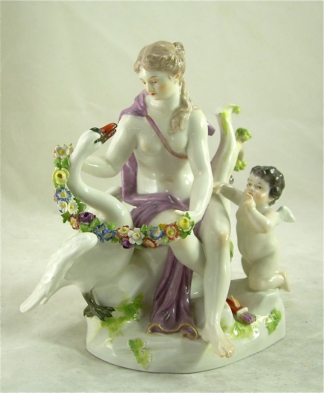 Porcelain figurine of a seated woman with flowers and a small child at her side