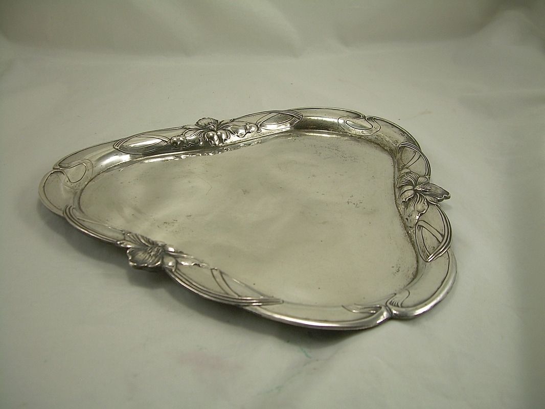 Silver ornate serving tray on a white surface