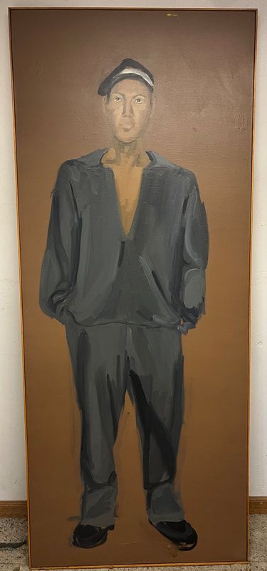 Full-length portrait of a man in a dark suit and cap standing against a brown background.