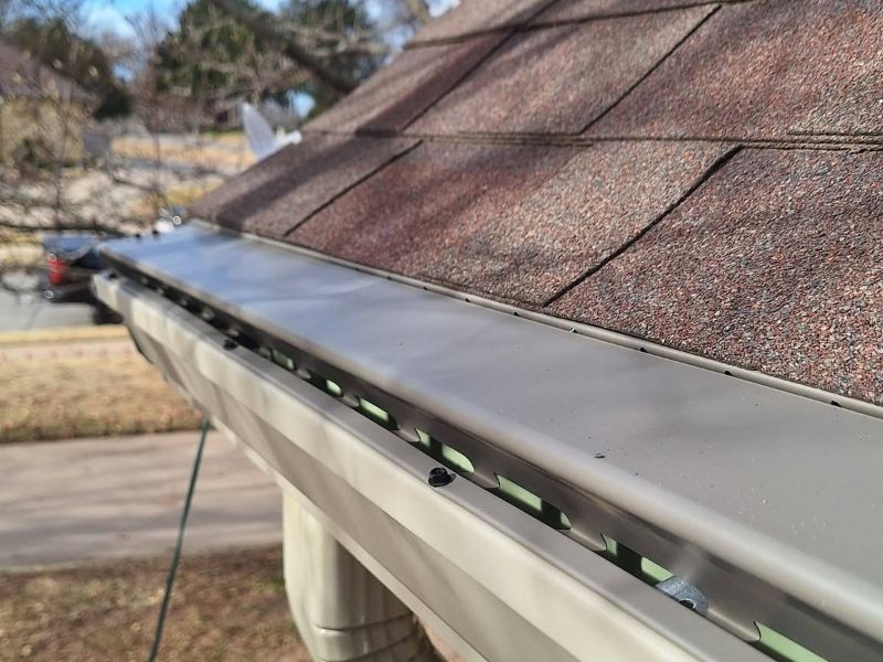 Crew installing seamless guttering on an Oklahoma home