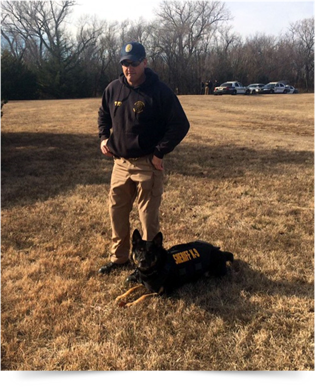 A man standing next to a dog with the number 11 on it
