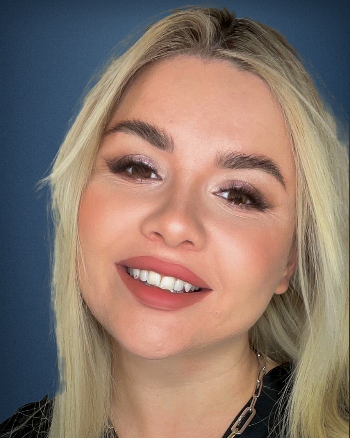 A close up of a woman 's face with a smile on her face.