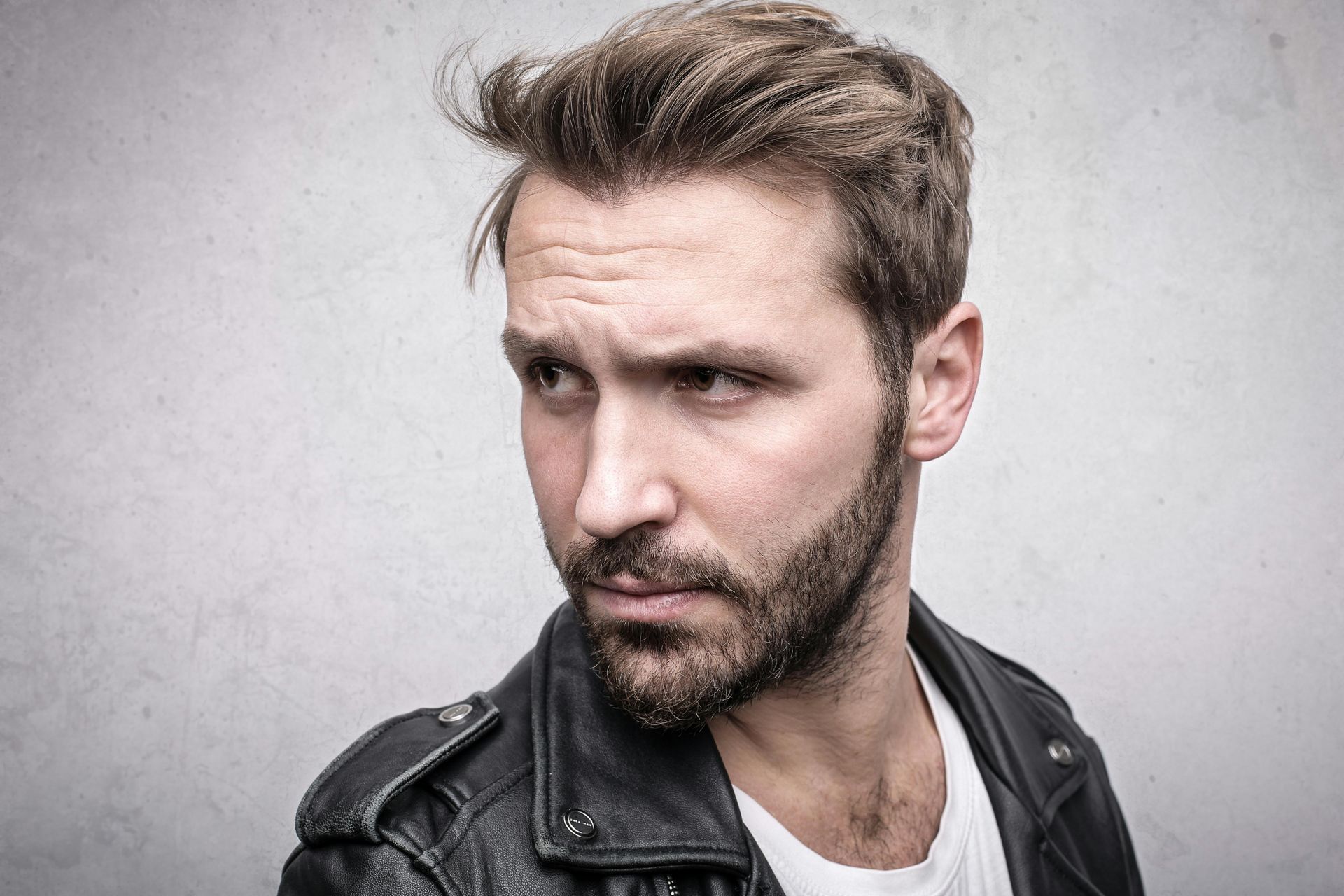 An attractive man with a beard is smiling for the camera