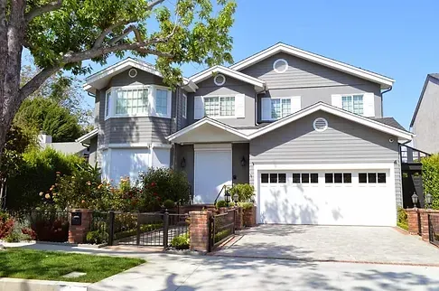 A large gray house with a white garage door