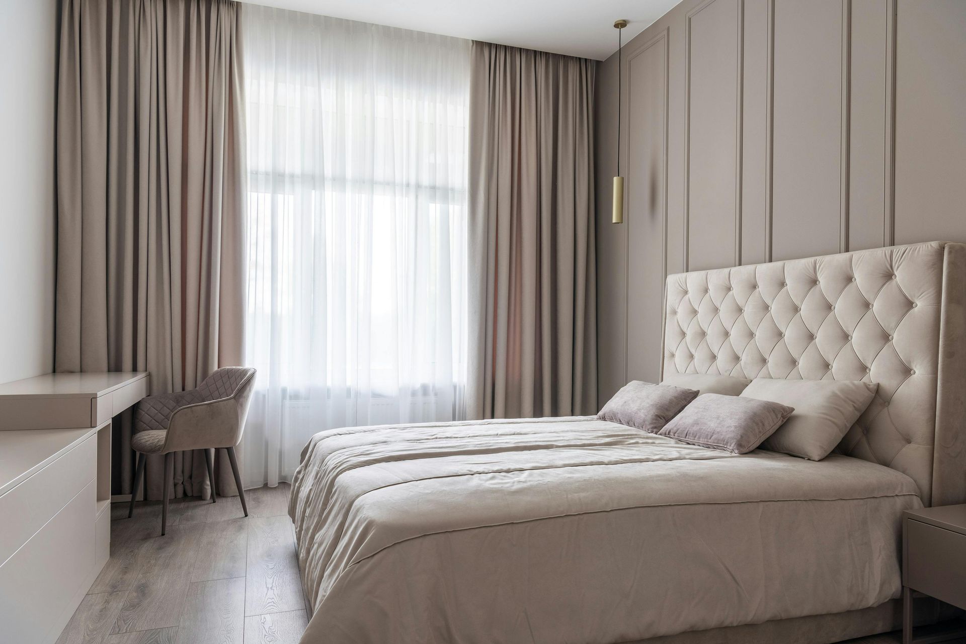 Interior of a beige bedroom eityh a large bed and headboard— McCormick Upholstery In Coolum Beach, QLD