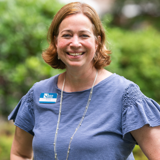 Woman wearing a navy polo shirt with