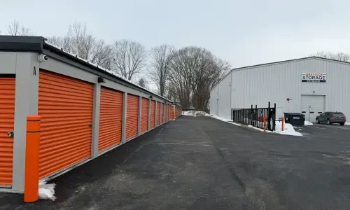 picture of a row of outdoor storage units with orange doors
