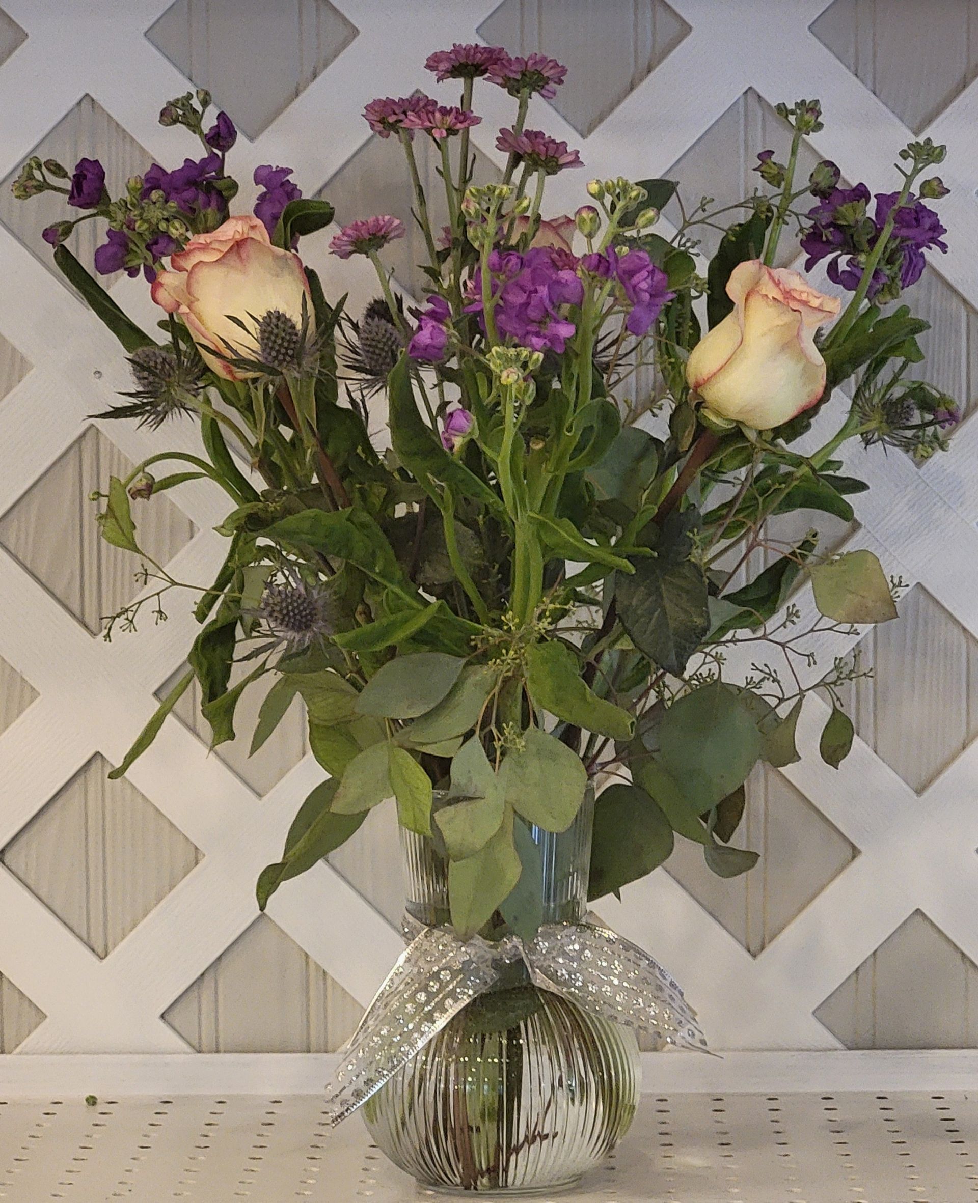 A basket filled with flowers is sitting on a table.