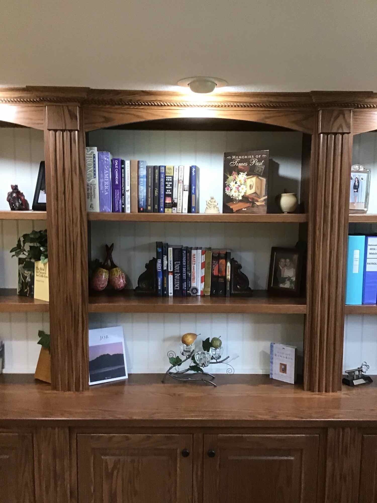 Wooden bookshelf with books and decorative items.
