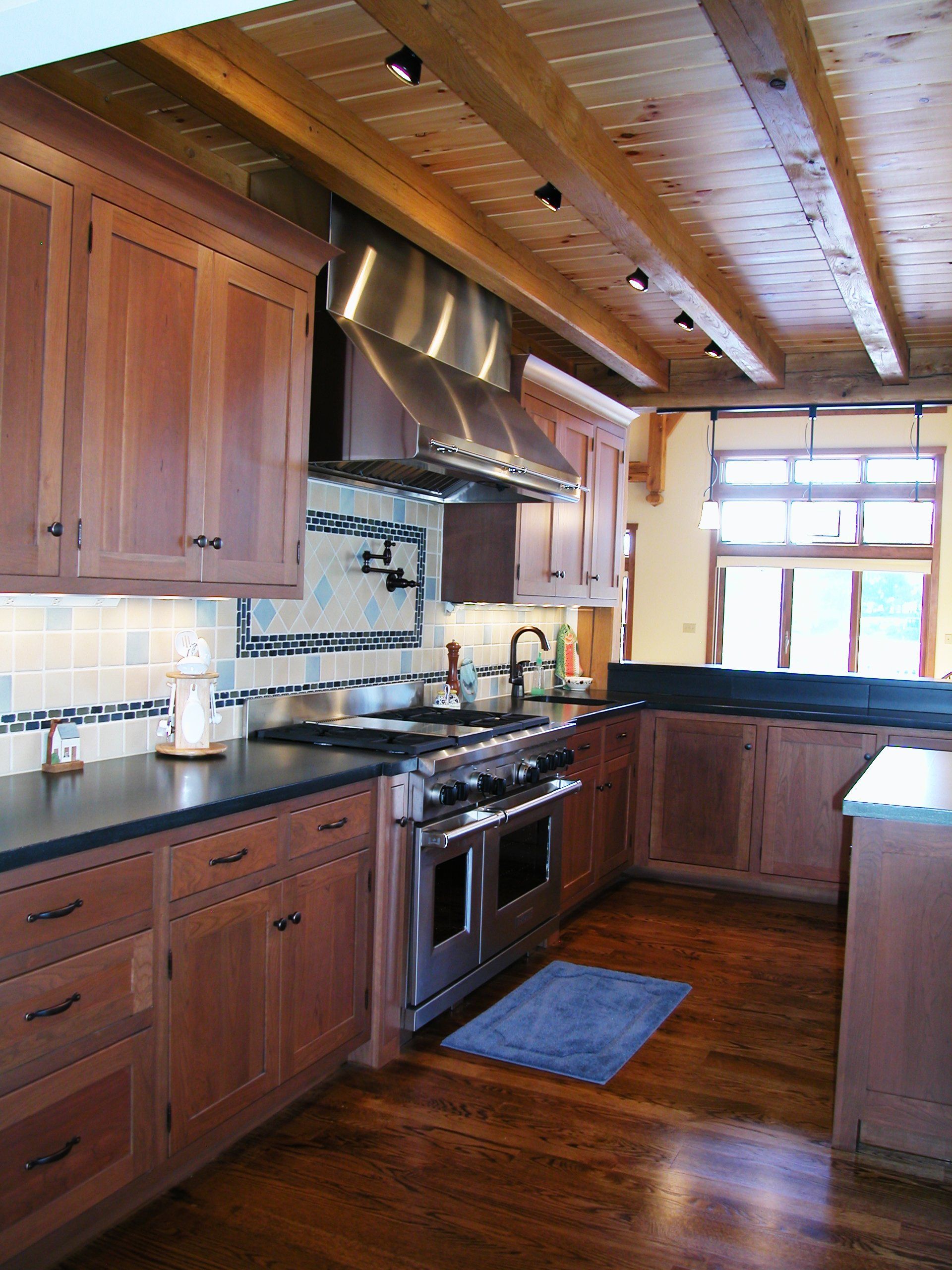 A kitchen with wooden cabinets and stainless steel appliances.