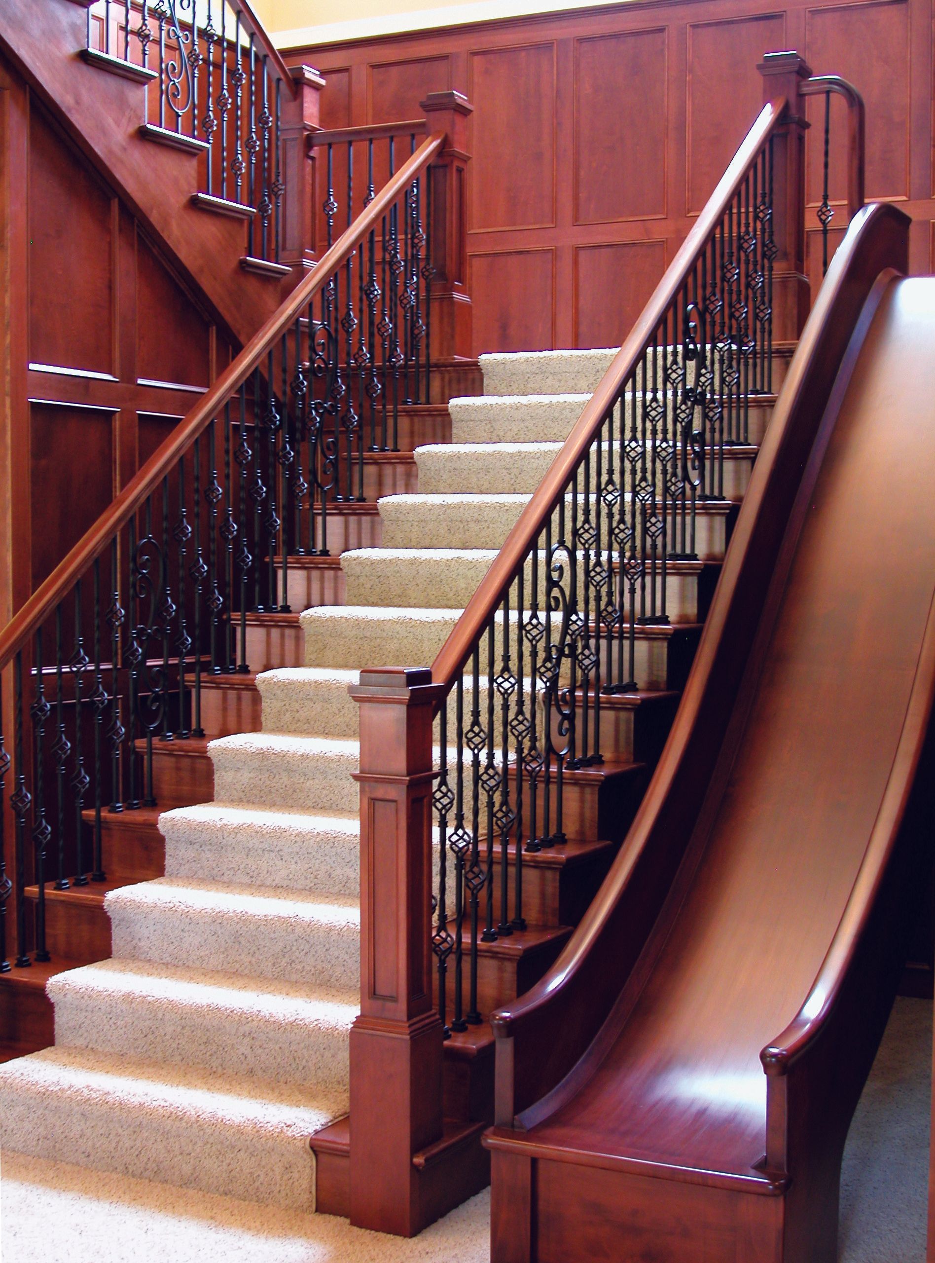 A wooden staircase with a slide underneath it