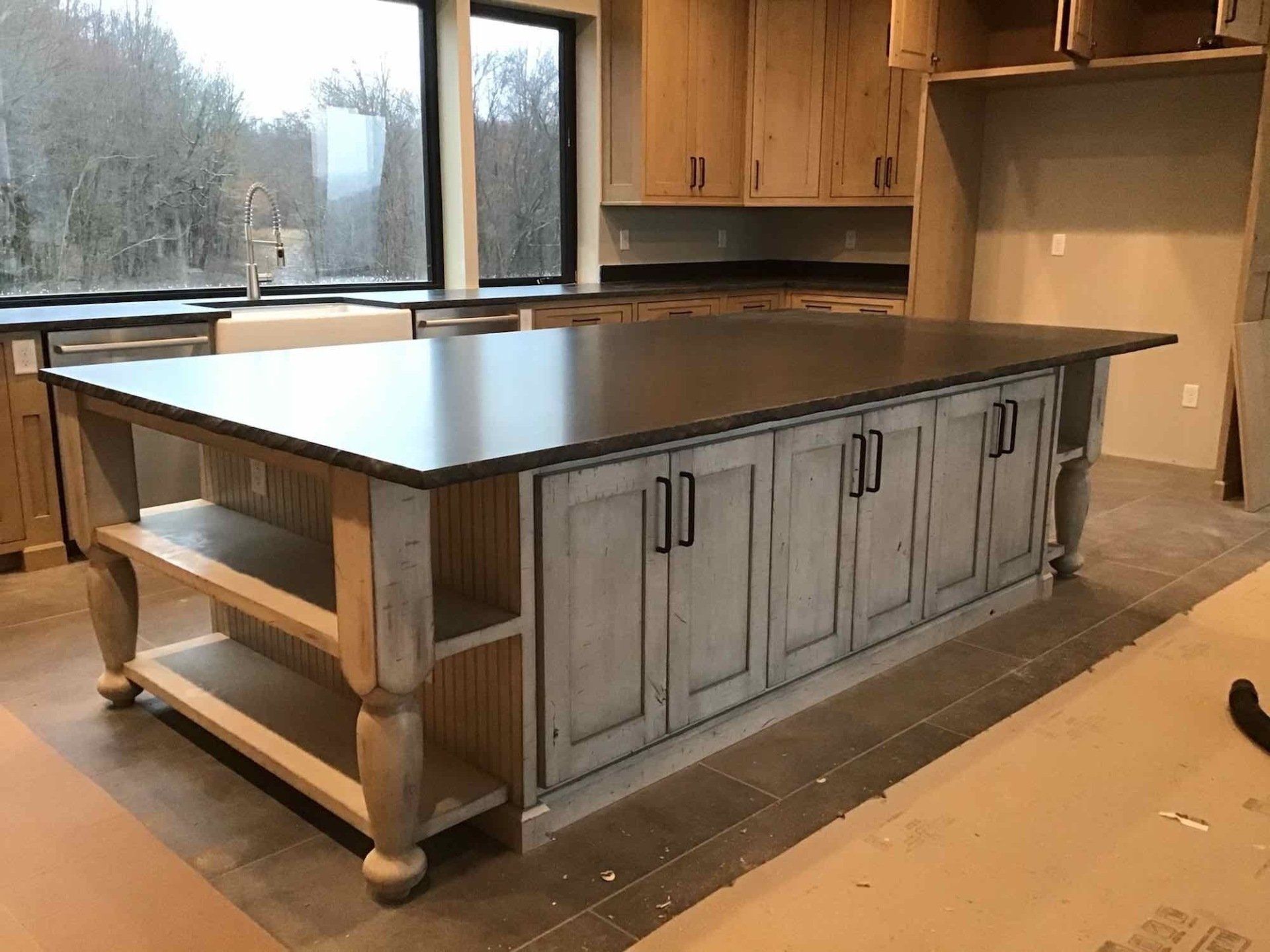 A kitchen with a large custom island in the middle.
