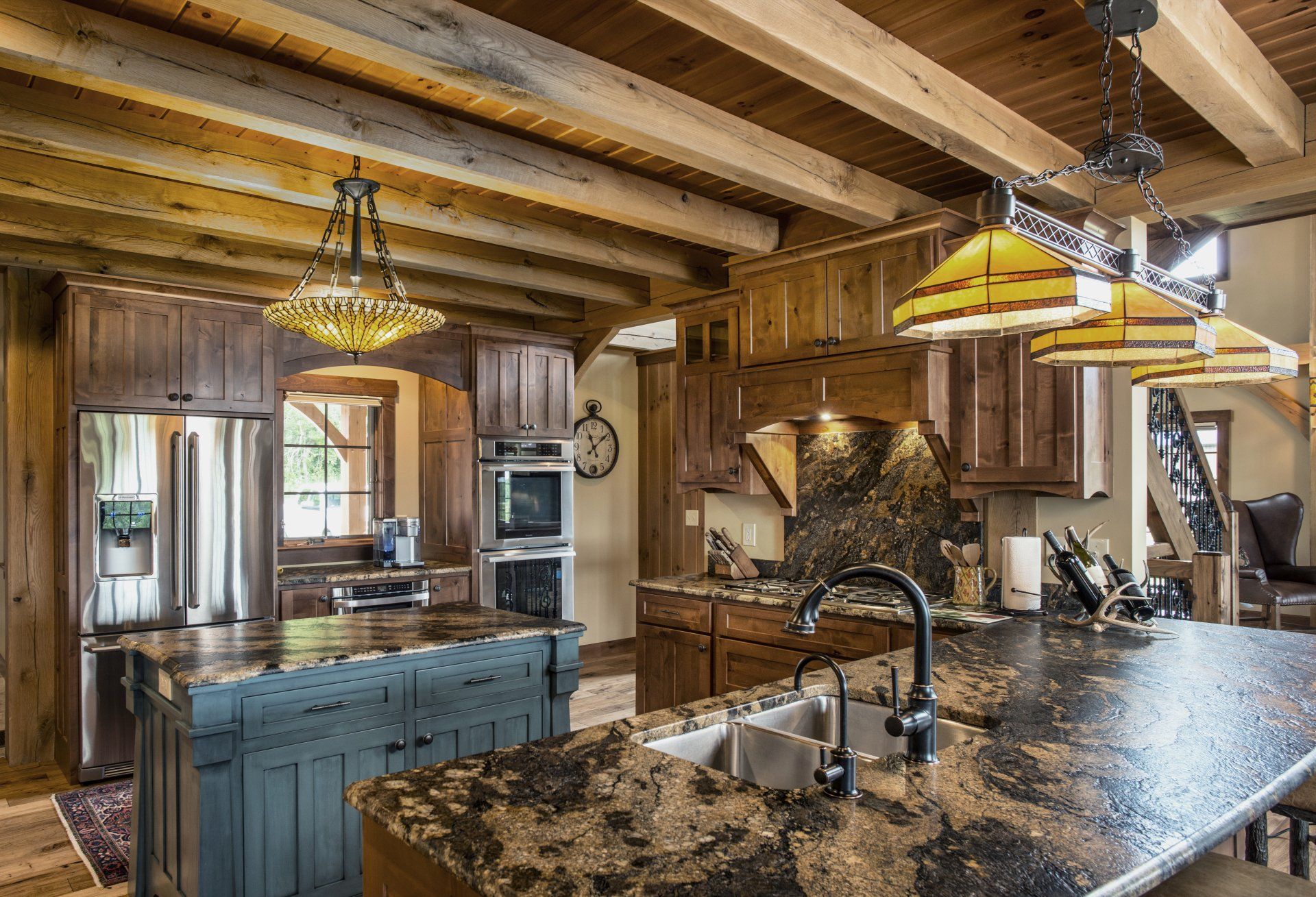 Rustic kitchen with wood cabinets, granite countertops, and two islands.
