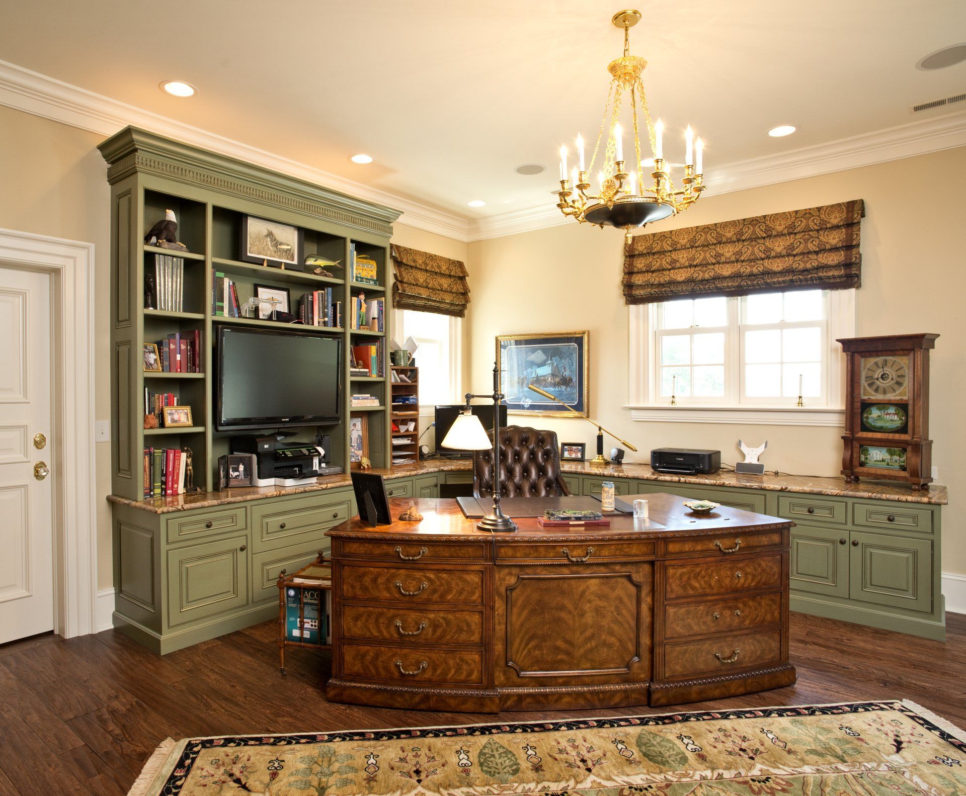 A home office with a desk and a television