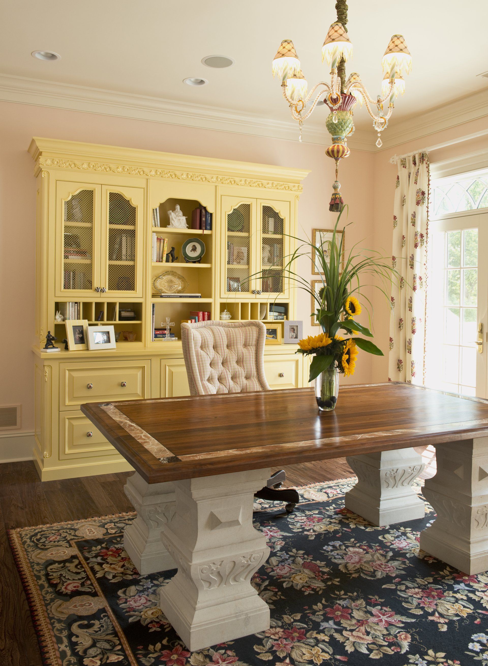 A room with a table and chairs and a chandelier