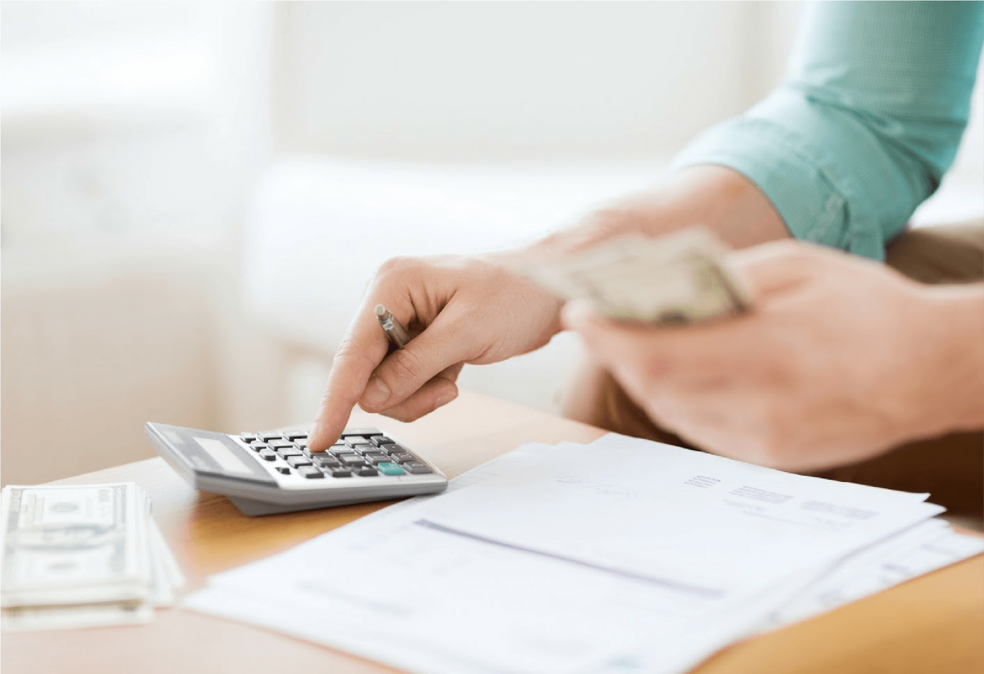 Man Counting Money And Using Calculator — Kansas City, KS — Ratliff Enterprises