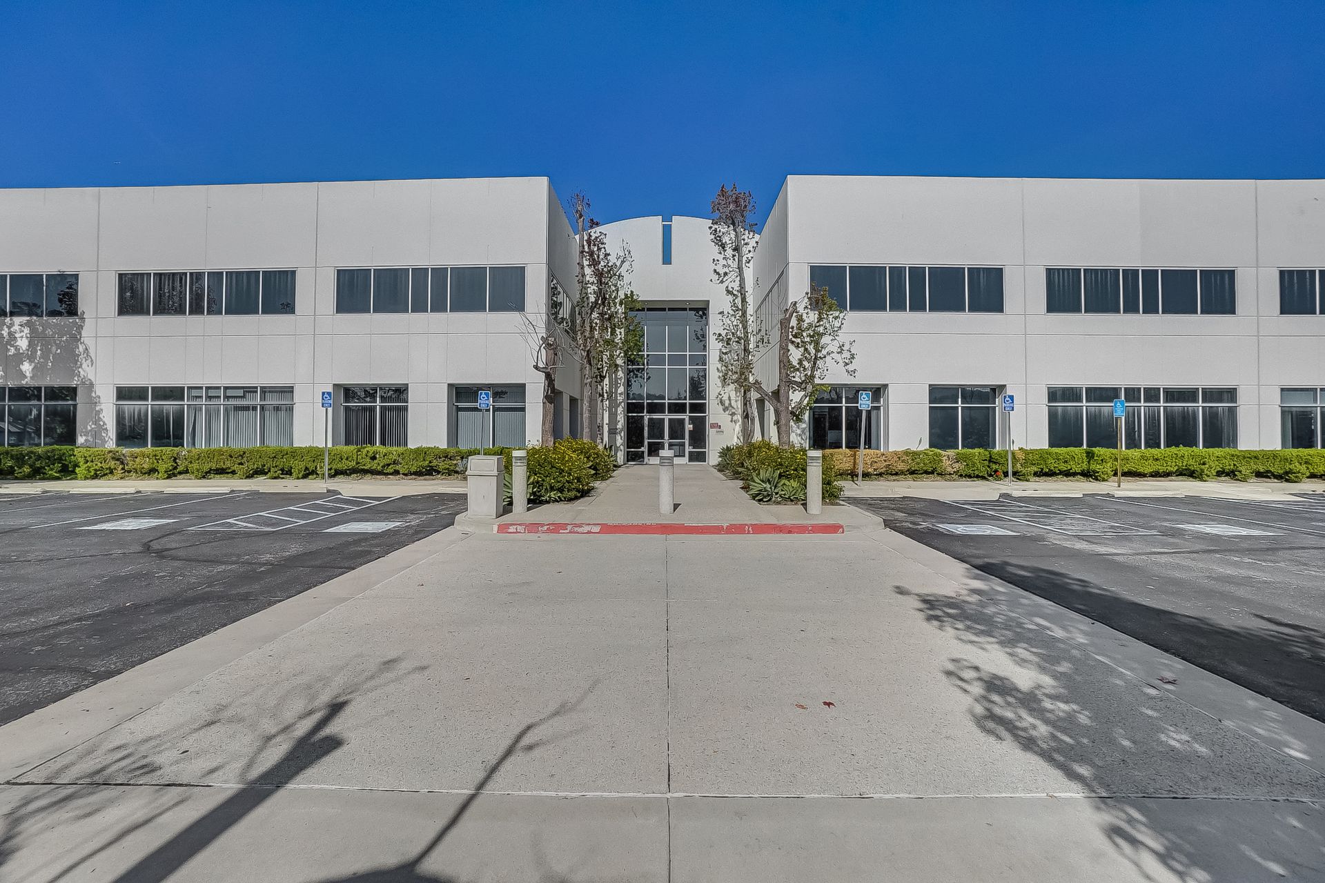 A large white building with a parking lot in front of it