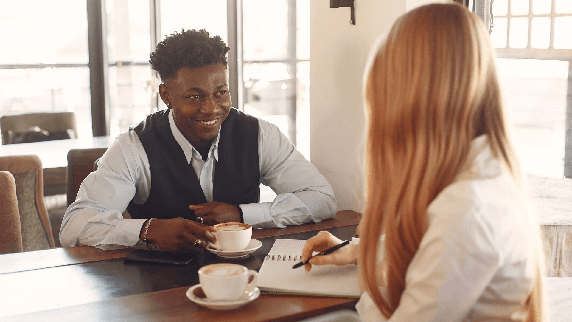 Two people talking at a table