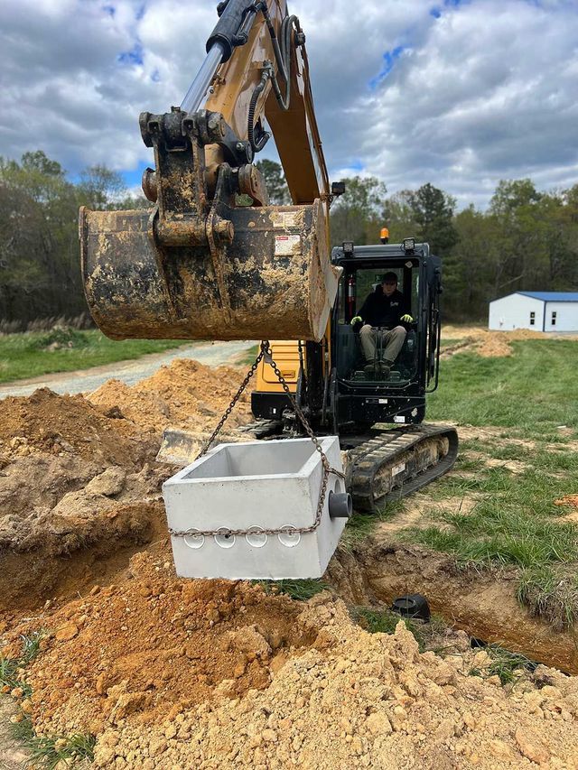 A man is driving a bulldozer in a dirt field.