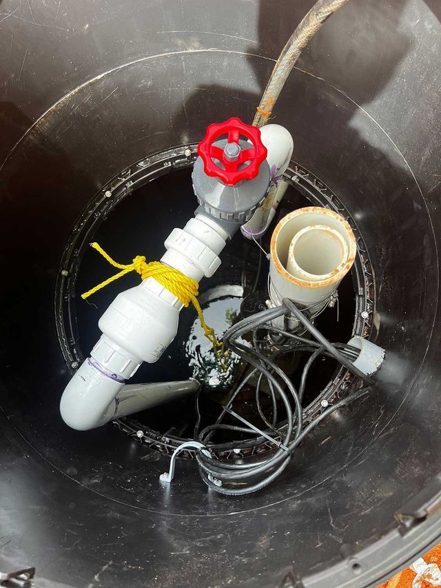 A red valve is sitting in the middle of a black hole.