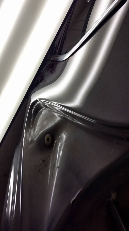 A close up of a car with a damaged fender