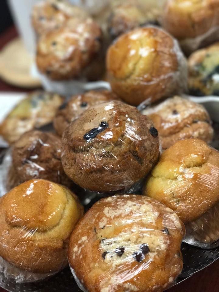 Close-up of glossy roasted pastries with dark filling, piled on a tray