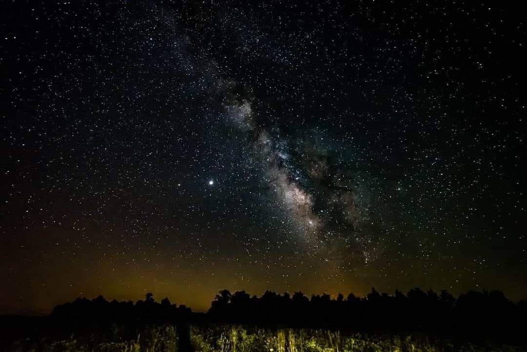 Wide-angle photograph of the Milky Way galactic core arcing over the upper Buffalo Valley on a clear