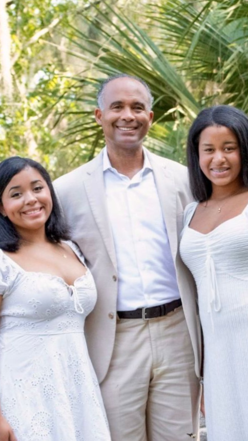 Warren McKenna III with his two daughters outdoors in New Orleans. 