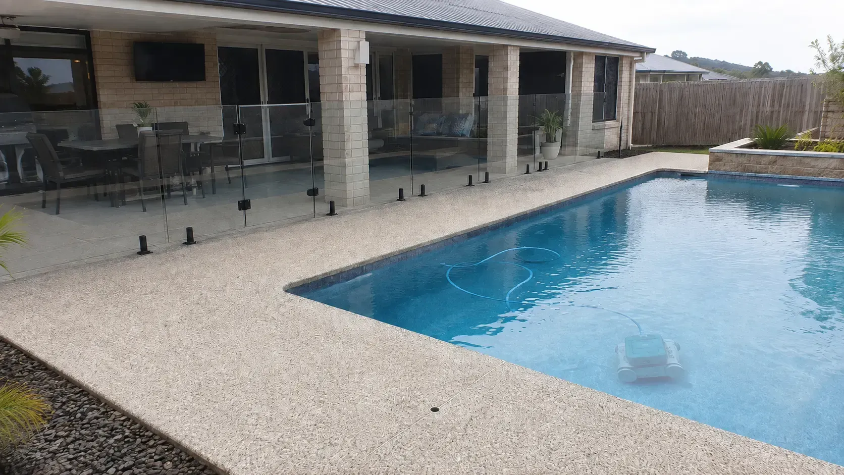 Exposed aggregate concrete pool surround. This is a great option for wet areas as it provides excellent grip.