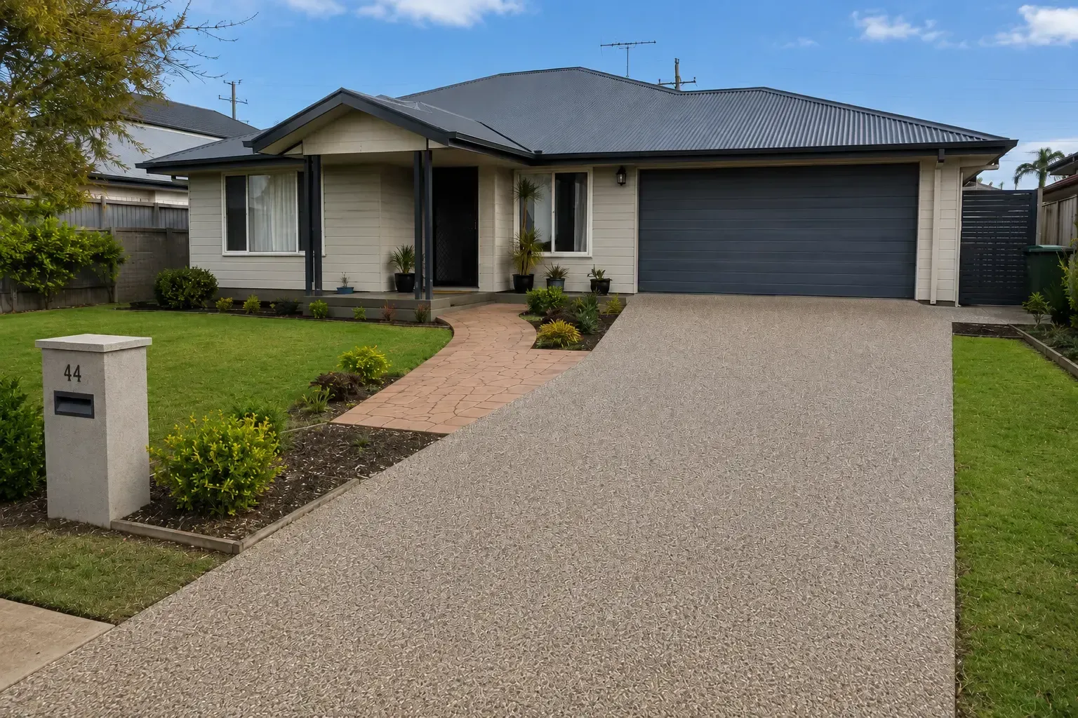 A recently completed exposed aggregate concrete driveway at this Middle Ridge home in Toowoomba
