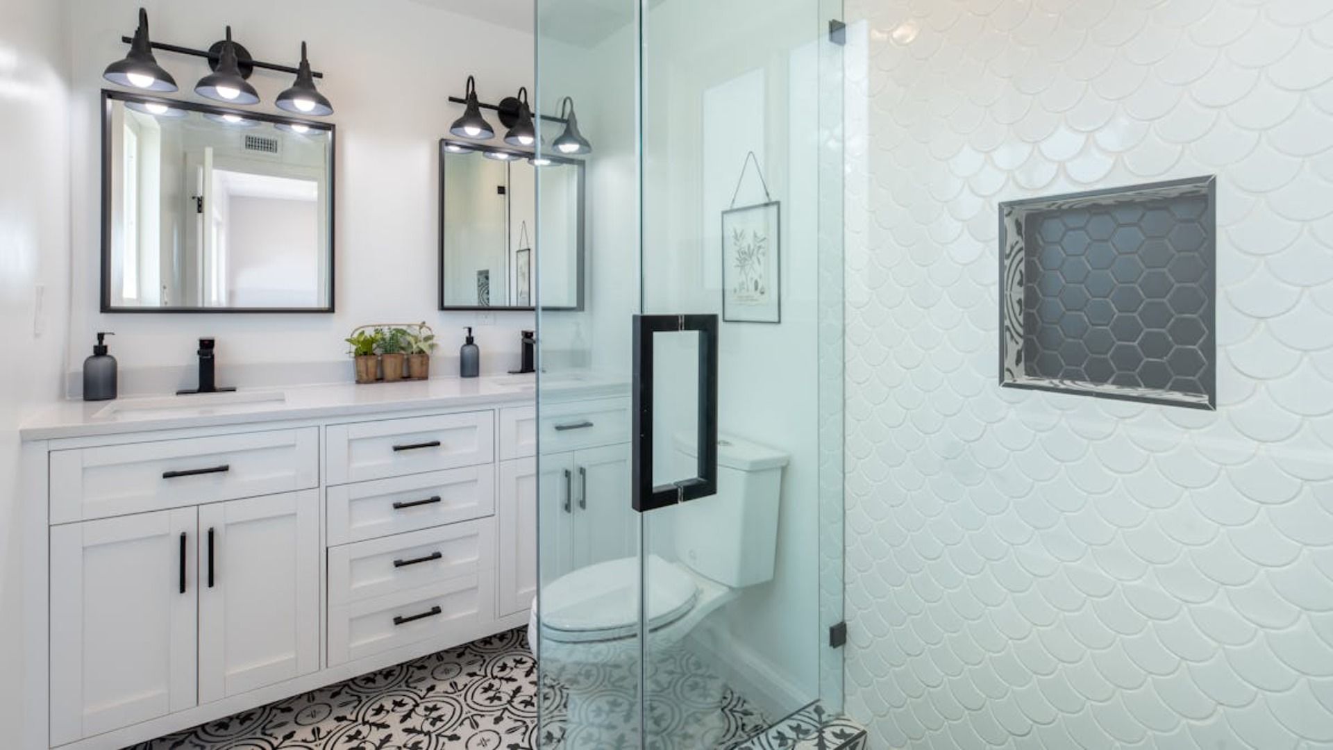 Un baño con inodoro, lavabo, espejo y ducha.