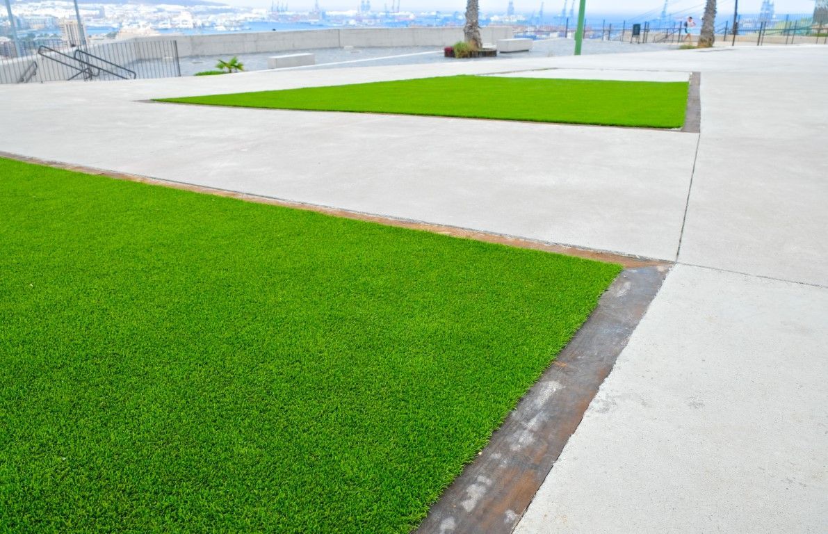 Rooftop terrace with artificial grass and city views.