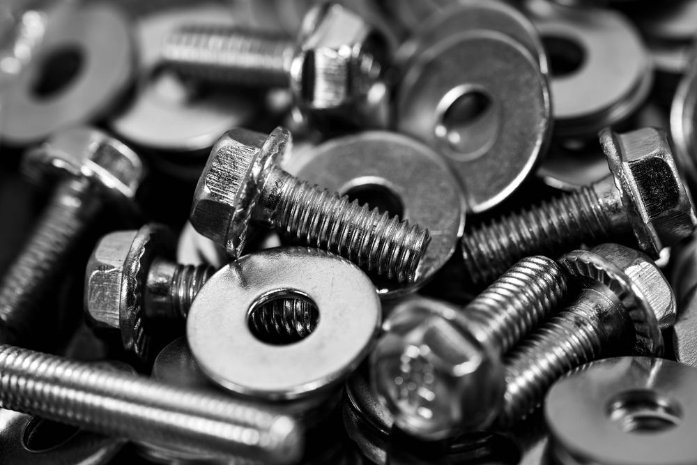 A Black And White Photo Of A Pile Of Nuts And Bolts — JA Toft & Co In Bundaberg Central, QLD