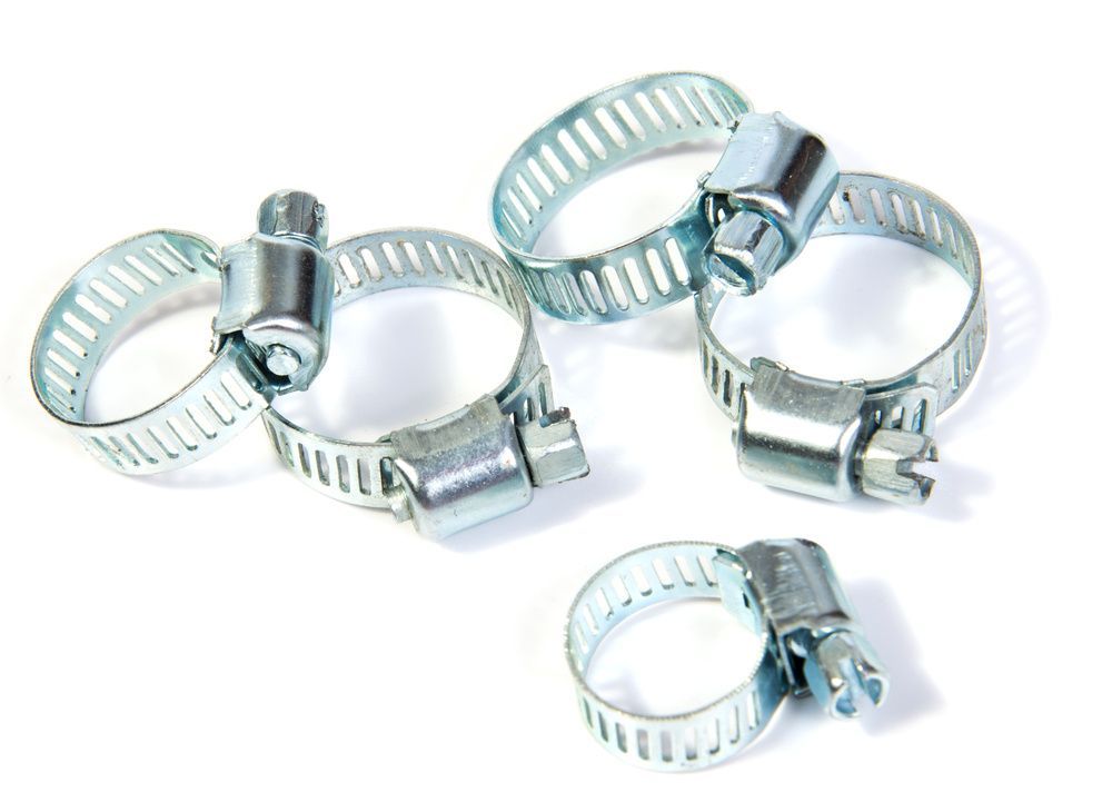 A Group Of Hose Clamps Are Sitting On Top Of Each Other On A White Surface — JA Toft & Co In Bundaberg Central, QLD
