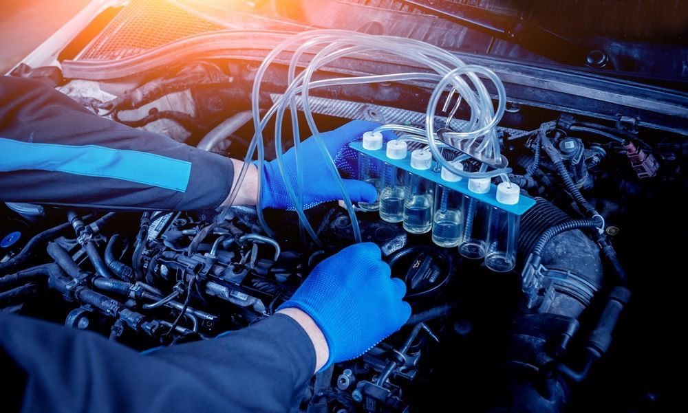 A Mechanic Is Working On The Engine Of A Car — JA Toft & Co In Bundaberg Central, QLD
