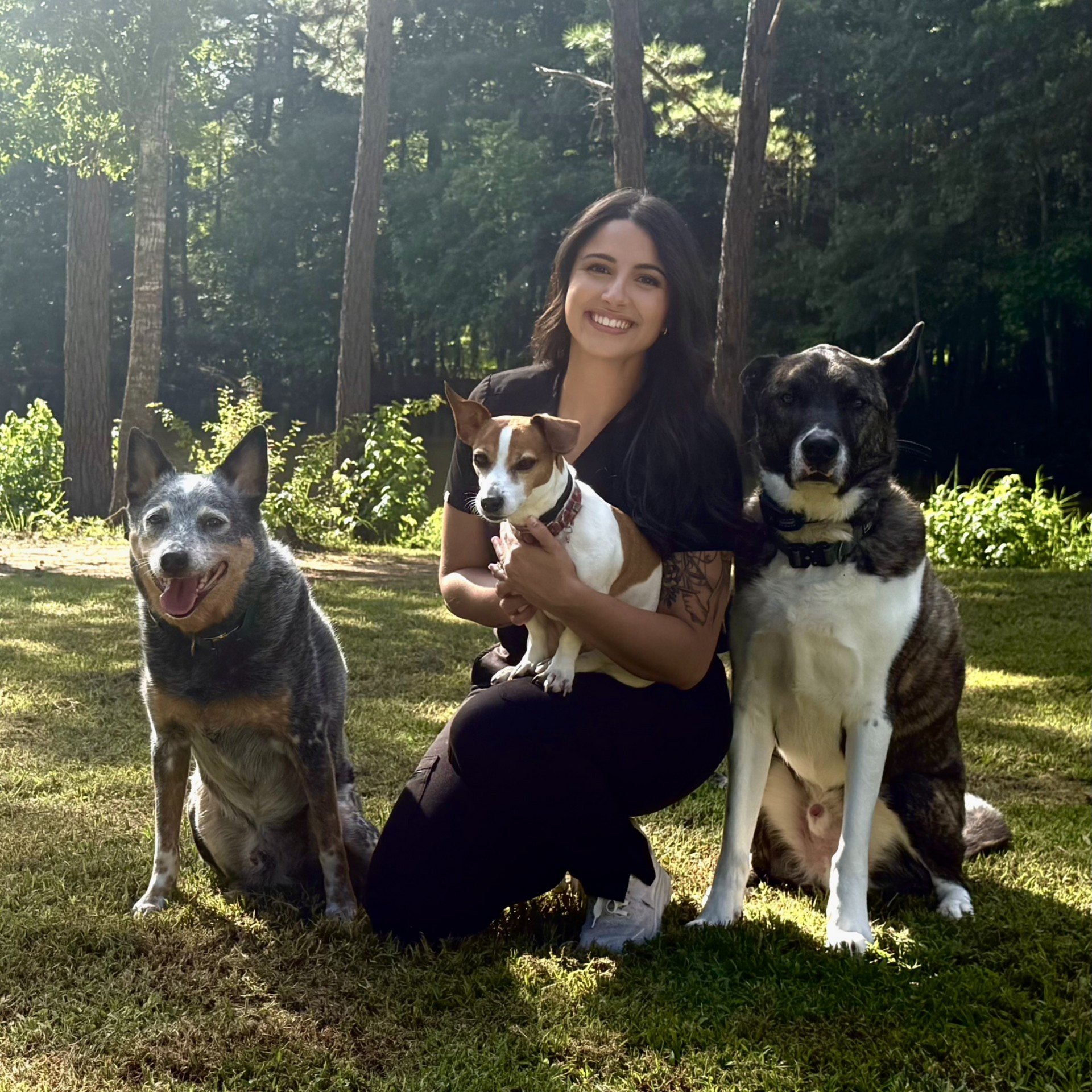 Dr. Caroline Ferreira with her three dogs