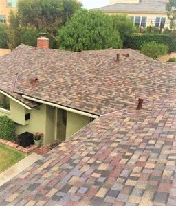 Roofing — Man drilling on the roof in San Dimas, CA Roofing — Man drilling on the roof in San Dimas, CA
