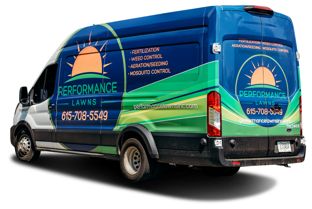 A blue and green van with the logo for Performance Lawns, with a phone number on the side.