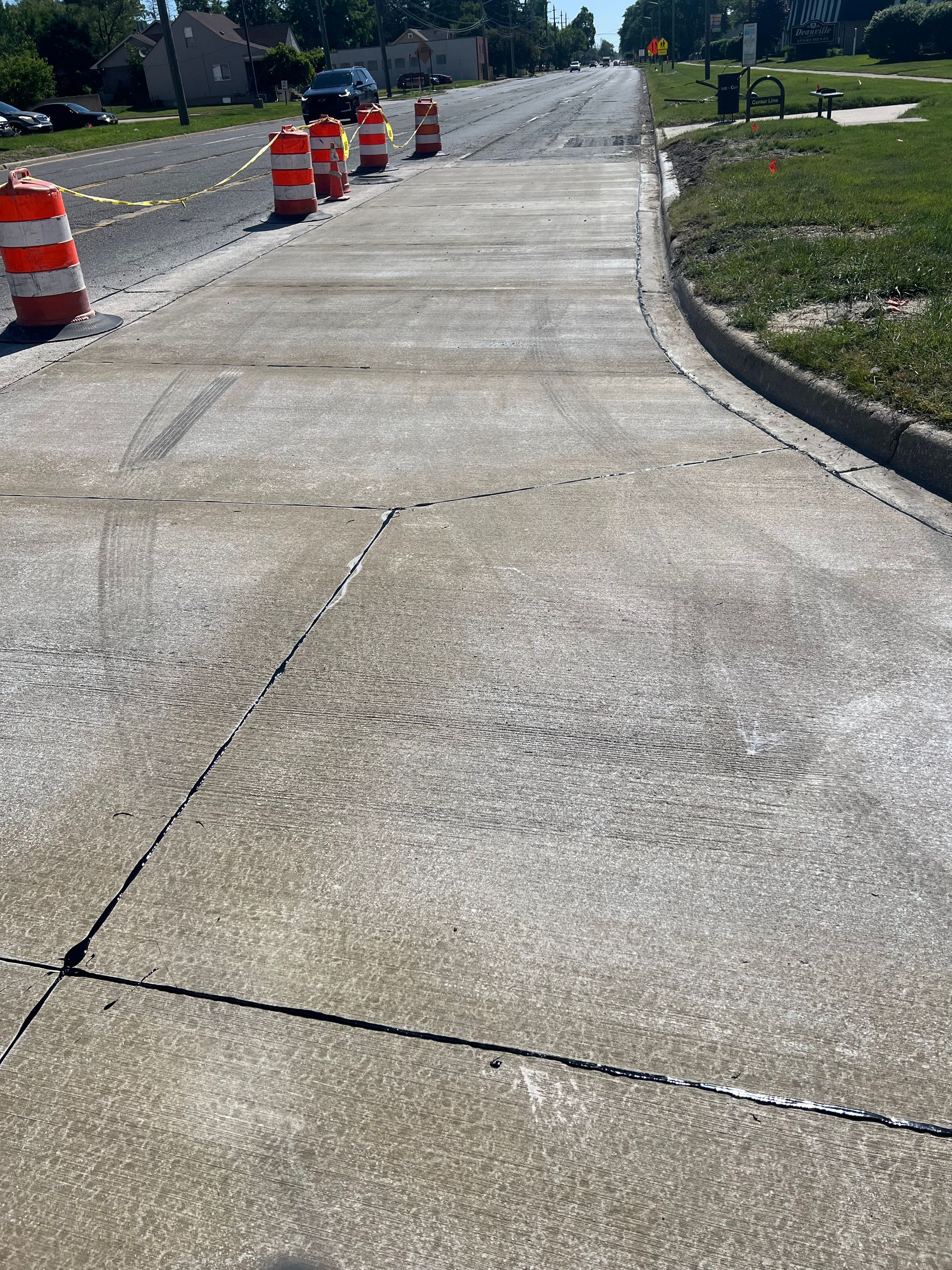 Black sealant applied to a concrete joint. Gray concrete with texture.