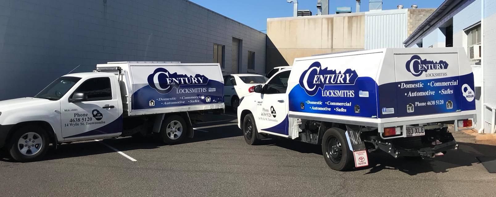 Two White Trucks With Century Business Logos Parked Outside a Building — Century Locksmiths in Dalby, QLD
