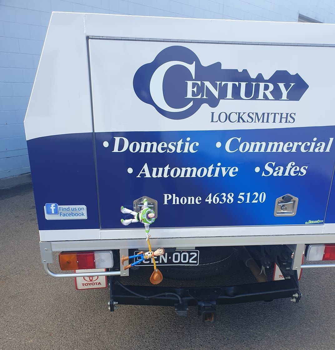 A Man Is Fixing a Door Knob with A Screwdriver — Century Locksmiths In Toowoomba City, QLD