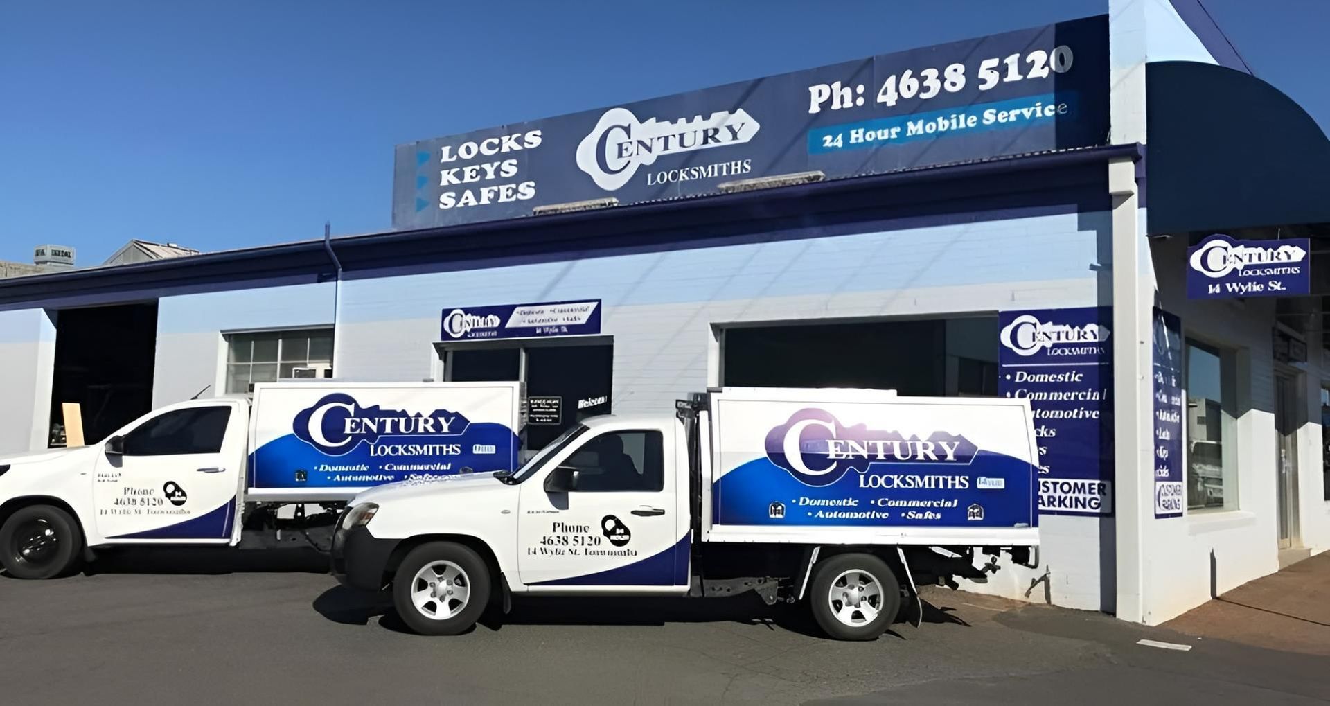 Two Century Trucks Are Parked in Front of A Building — Century Locksmiths In Toowoomba City, QLD