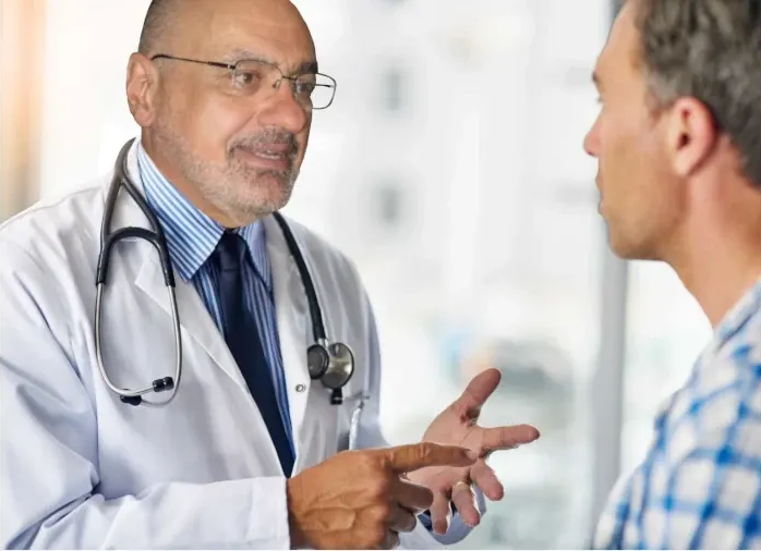 male doctor confers with a male patient