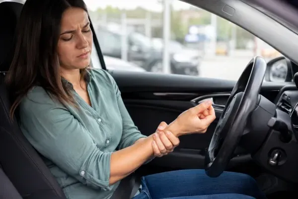 woman in car with wrist pain