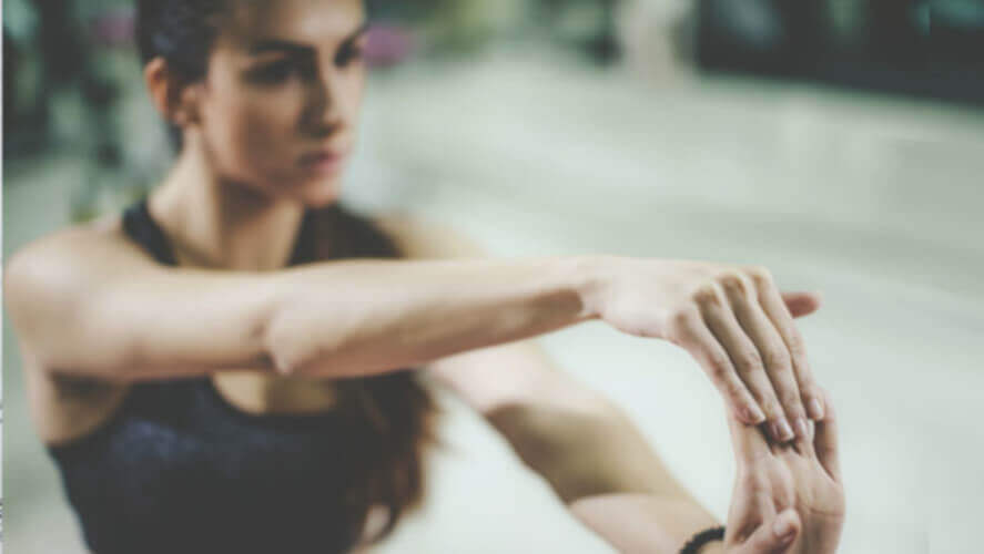 woman performing finger stretching exercise