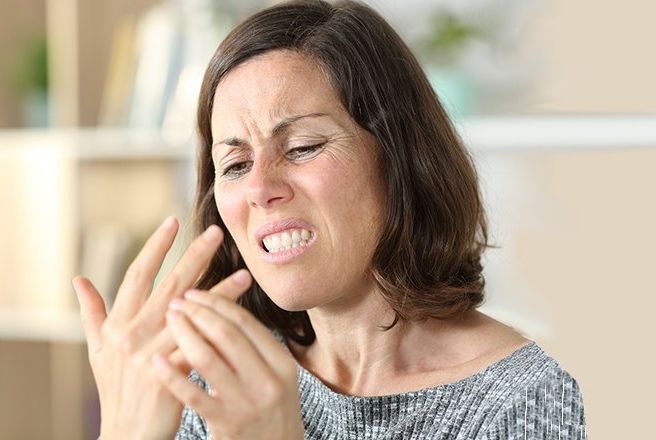 woman with sharp finger pain